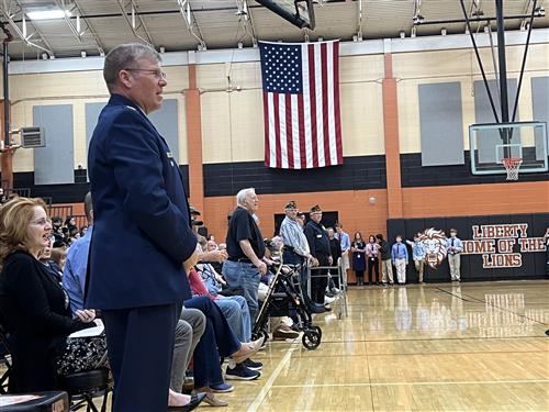 veterans standing to be recognized at gym ceremony at Liberty Middle